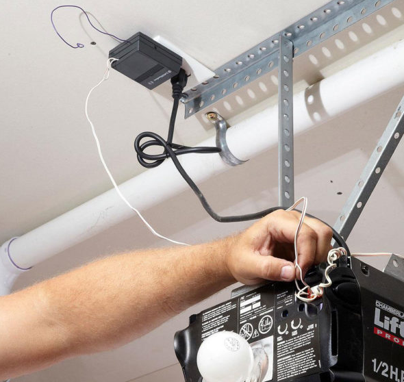 Technician performing a garage door opener installation for a residential property in Delaware.