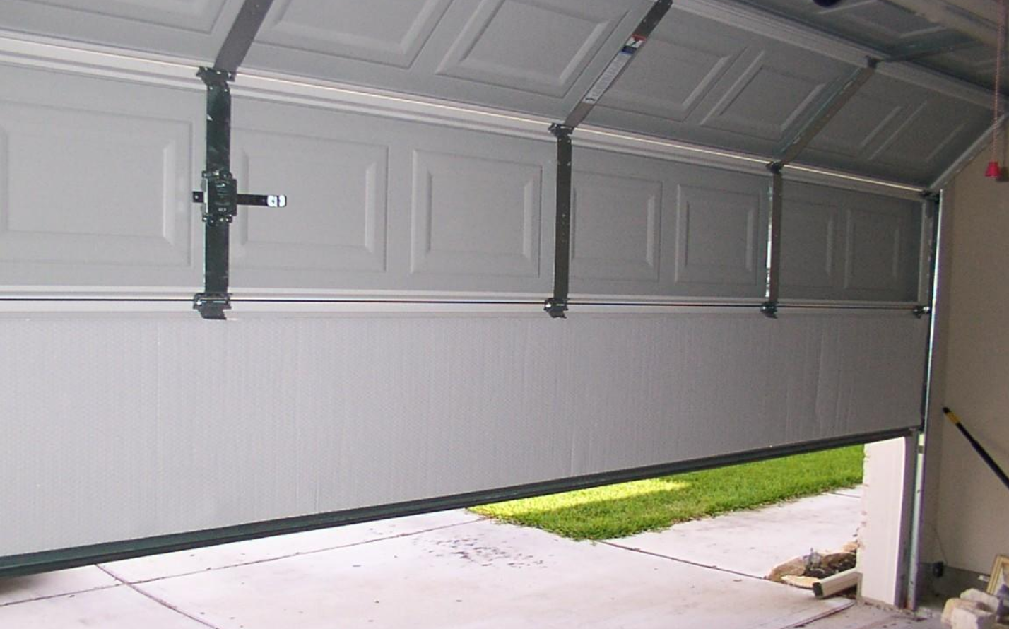 Close-up of a technician on fixing garage door section in Delaware, showcasing professional garage door repair services